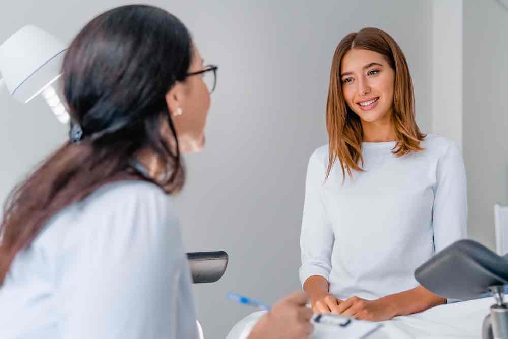 Gynecologist-talking-with-a-young-female-patient-about-womens-integrated-healthcare