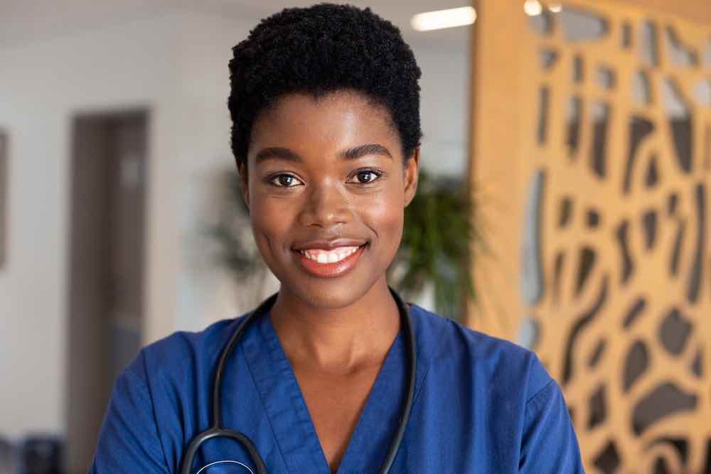 Portrait of a happy African American doctor practicing womens integrated healthcare.
