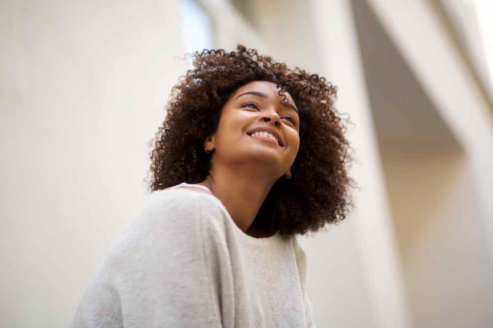 Close up of a smiling African American woman experiencing quality women’s care.
