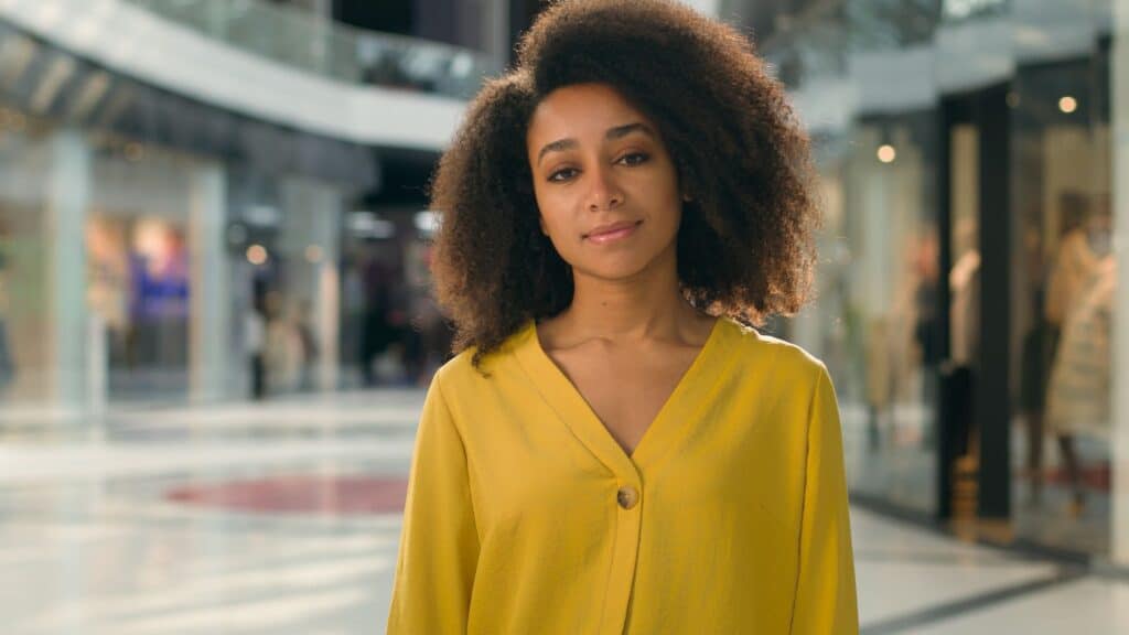 Woman in a yellow sweater who’s learned the truth behind myths about women’s health.
