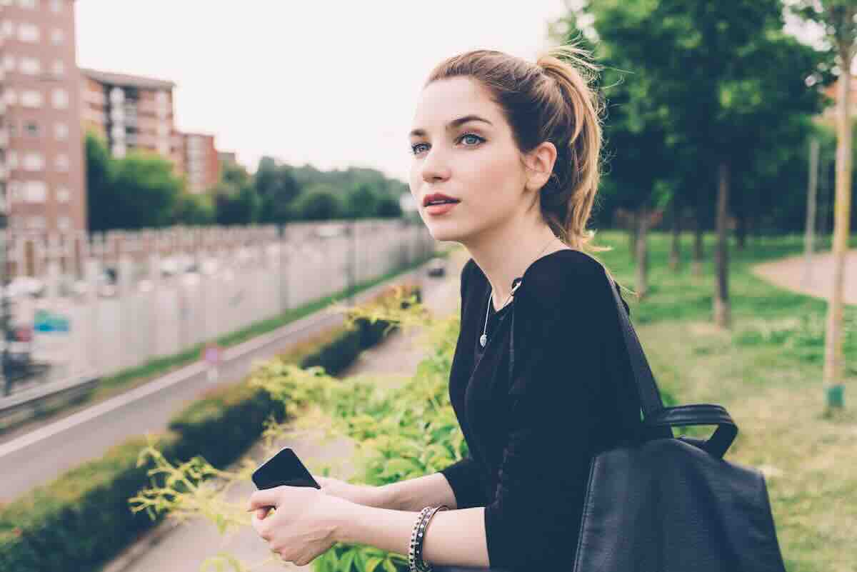 Woman with a ponytail standing outside and asking how long do STD results take?