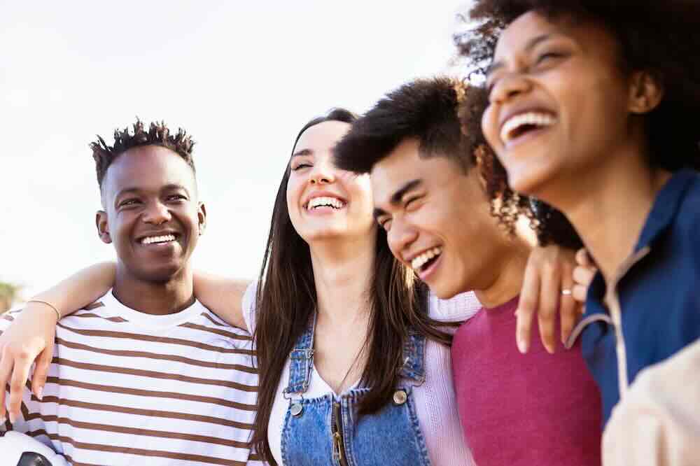 Four happy friends outdoors who know what is the STD rate in St Louis Missouri.