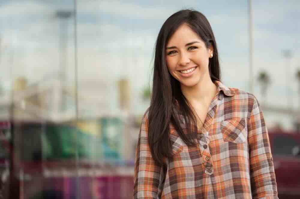 Woman in a plaid shirt standing by a store window and asking what is the STD rate in St Louis Missouri?