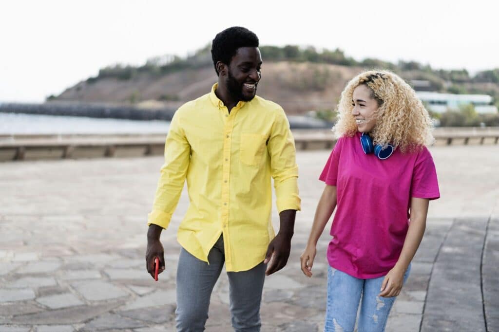 Multi Racial couple holding hands, considering abortion pill side effects